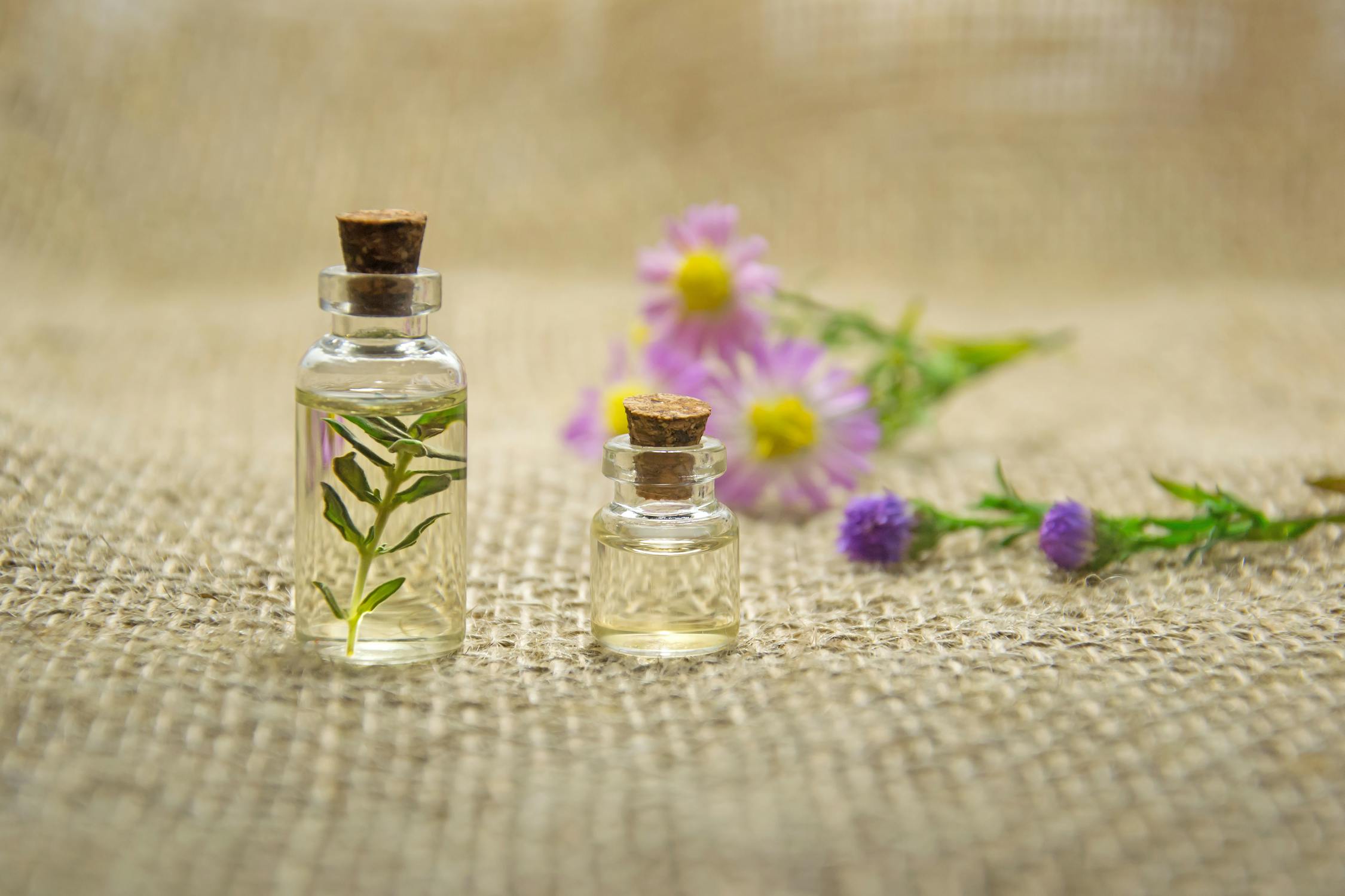Close-up of essential oil bottles, some with visible labels that could represent ethical or organic certifications.
